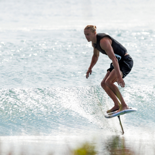 Man riding a Ronix Wake foil board in the ocean