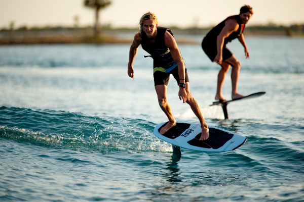 Two men riding wakefoils together