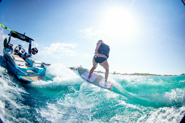 Woman riding a Ronix wakesurf board