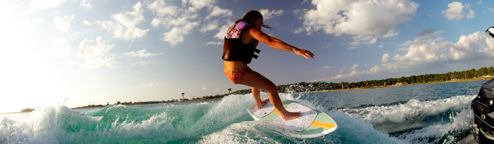 Woman riding a Ronix Wakesurf Board